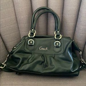 Black coach purse with purple lining